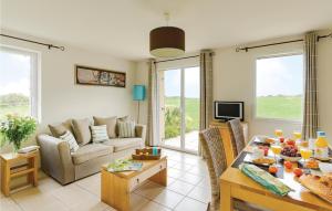 a living room with a couch and a table at Les Hauts De La Houle in Cancale