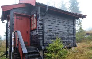 a small cabin with a red door and stairs at Three-Bedroom Holiday Home In Sjusjoen in Sjusjøen