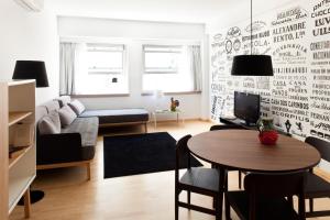 a living room with a table and a couch at The Lisbonaire Apartments in Lisbon