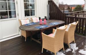 a table and chairs on a porch with snow on it at Gorgeous Home In Mollsund With Kitchen in Mollösund