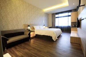 Postel nebo postele na pokoji v ubytování Yu Chun Hotel