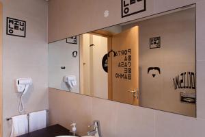 a mirror in a bathroom with a sink and a phone at The Lisbonaire Apartments in Lisbon +37 photos