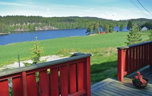 a wooden deck with a view of a large lake at 3 Bedroom Cozy Home In Hemnes in Vortungen