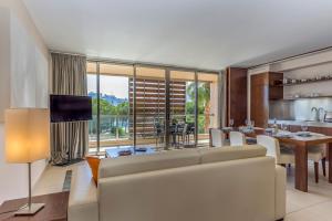 a living room with a couch and a dining room at FLH Salgados Beach Apartment in Guia