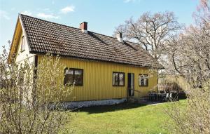 a yellow house with a black roof at 3 Bedroom Beautiful Home In Lttorp in Löttorp