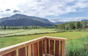 a wooden deck with a view of a field and mountains at Amazing Home In Hemsedal With 3 Bedrooms in Hemsedal