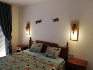 a small bedroom with a bed and two night stands at Carib Playa Marbella apartments in Marbella