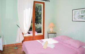 a bedroom with a pink bed with a cross on it at Amazing Home In Roussillon With Wifi in Roussillon