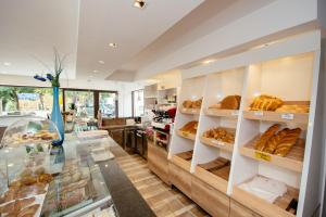 a bakery with a display case filled with pastries at Sunny Rooms in Most na Soči