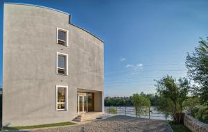 a concrete house with a cylindrical facade at Four Seasons Riverside in Kutaisi