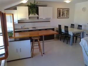 a kitchen with a counter and a table and chairs at Apartments Edo in Novigrad Istria