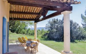 a patio with a table and chairs under a pergola at Amazing Home In Roussillon With Wifi in Roussillon