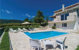 a villa with a swimming pool in front of a house at Cozy Home In Igalo With Wifi in Herceg-Novi