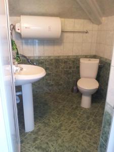 a bathroom with a toilet and a sink at Guest House Emi in Balchik +27 photos
