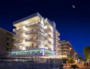 a white building with a moon in the sky at Hotel Ghirlandina in Rimini