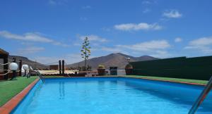 una piscina con montañas en el fondo en Casa de Campo Hiurma, en Triquivijate