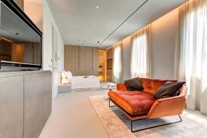 a living room with a orange couch and a kitchen at Villa Italia in Cesenatico