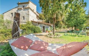 a bed with pillows in front of a building at Casale Petrucci in Vacone