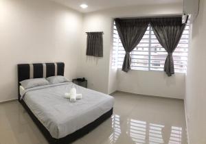 een slaapkamer met een bed met twee kaarsen erop bij De Little Cabin - 7mins to Sunway Iost World of Tambun in Ipoh
