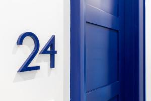 a blue door with the number twenty four on it at Hotel Mignon Meublè in Sorrento