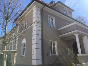 a large house with a white brick at Apartments Thommen Lohengrinstr in Nürnberg