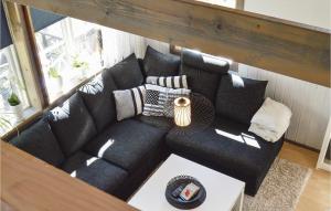 a black couch in a living room with a table at Lovely Home In Strängnäs With Kitchen in Strängnäs