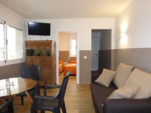 a living room with a couch and a table at Rentalmar Delfos Playa in Salou