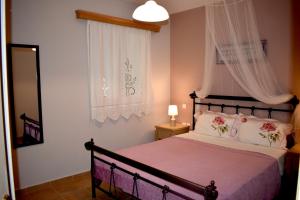 a bedroom with a bed and a window at Kakia 2 Bedroom Apartment in Zakynthos Town