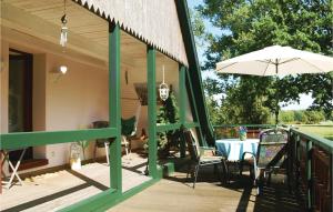 a porch with a table and an umbrella at Gorgeous Apartment In Marlow Ot Brnkendorf With Kitchen in Marlow