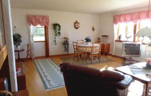 a living room with a couch and a table at Lovely Home In Mattmar With Kitchen in Arvesund