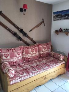 a bedroom with a bed with red and white pillows at L appart' du bonheur in Ancelle