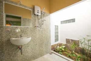 a bathroom with a sink and a shower at La Terrazza in Hoi An