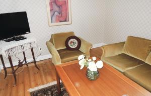 a living room with two chairs and a coffee table at Holiday Home Vätinge Mellangård Tranås in Gripenberg