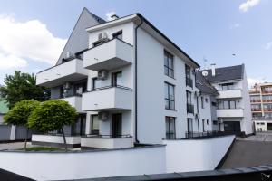 a white building with a ramp in front of it at Art Apartments in Hajdúszoboszló