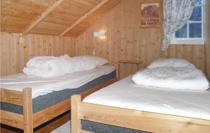 ØveråsにあるNice Home In Eresfjord With 2 Bedroomsの木造キャビン内のベッド2台が備わる部屋