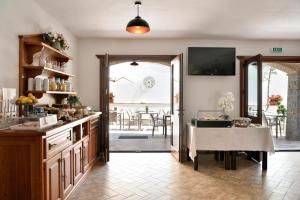 a kitchen with a table and a dining room at Hotel Goloritzé in Baunei