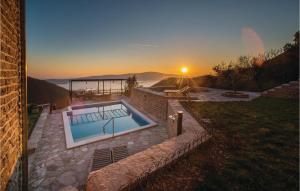 a swimming pool with a sunset in the background at Beautiful Home In Tivat With Wifi in Tivat