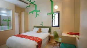 Un dormitorio con una cama con un osito de peluche. en Tanhui Modern Hotel, en Yuchi