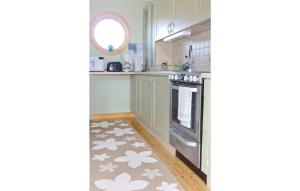 uma cozinha com armários brancos e um forno em 2 Bedroom Stunning Home In Gunnebo em Skälö