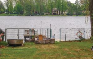 a fence next to a large body of water at Two-Bedroom Holiday Home In Neue Muhle in Neuemühle