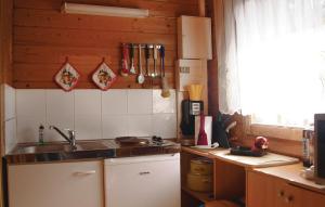 a kitchen with a sink and a stove and a window at Nice Home In Wolgast Ot Hohendorf With 2 Bedrooms in Zarnitz