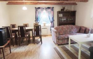 a living room with a couch and a table at Awesome Home In Ryd With Kitchen in Ryd