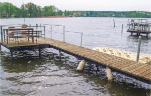 a wooden dock in the middle of a lake at 2 Bedroom Gorgeous Home In Neue Mhle in Neuemühle