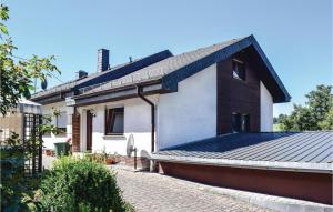 a house with a metal roof on a street at 2 Bedroom Nice Home In Sellerich in Sellerich
