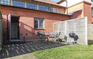 a patio with a table and chairs and a grill at Awesome Apartment In Ystad With 2 Bedrooms And Wifi in Ystad