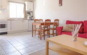 a kitchen and a living room with a table and chairs at Awesome Apartment In Ystad With 2 Bedrooms And Wifi in Ystad