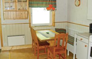a kitchen with a table and chairs and a window at Awesome Home In Ryd With Kitchen in Ryd