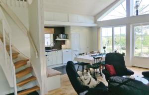 a kitchen and dining room with a table and chairs at Holiday Home Sandåkra Vetlanda in Vetlanda
