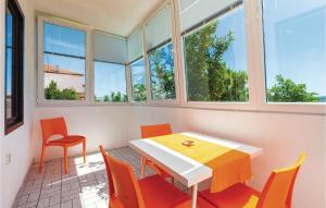 a room with a table and chairs and windows at Lovely Apartment In Crikvenica With Wifi in Crikvenica