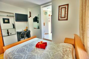 a bedroom with a bed with a red box on it at Haifa Guest House in Haifa +15 photos